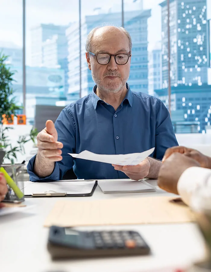 A senior Fincom Insights advisor reviewing incorporation and compliance documents with a client