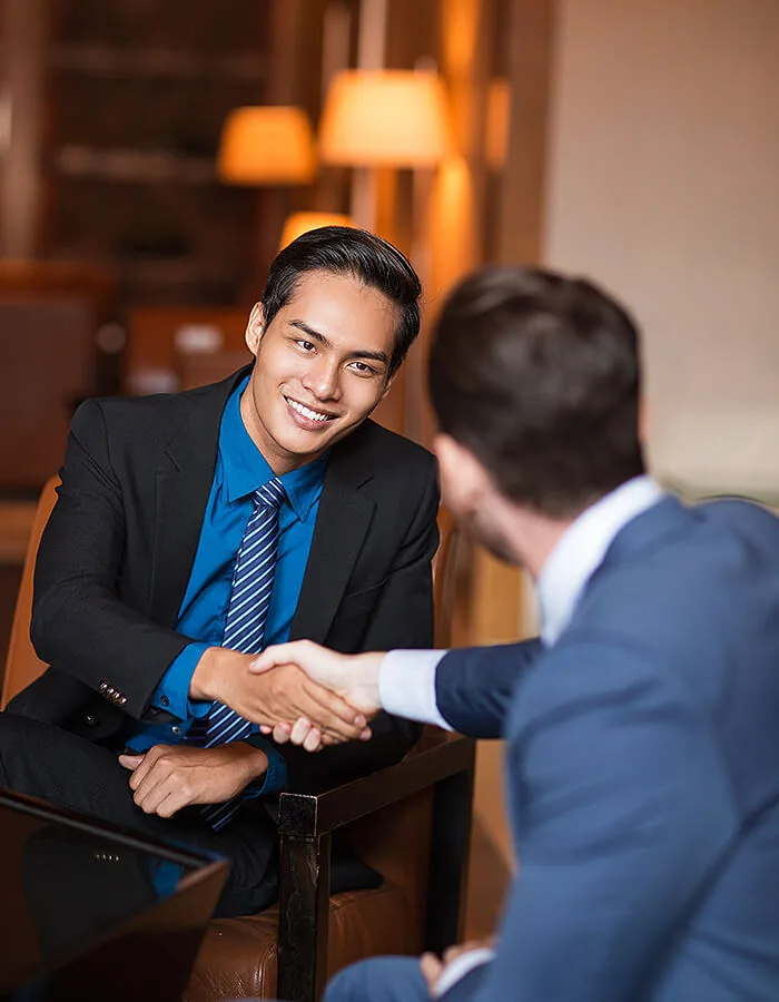 A founder and investor shaking hands after the trust and readiness work behind a fundraise